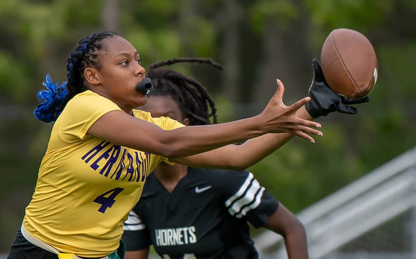 Hernando High, 4, Kayla Holloman reaches back for a reception Monday at Weeki Wachee High. [Photo by Joe DiCristofalo]