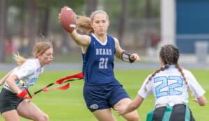 Central High, 21, Delanee Duncan reaches for extra yardage as Nature Coast Tech, 3, pulls her flag Wednesday evening at Central High. [Photo by Joseph DiCristofalo]