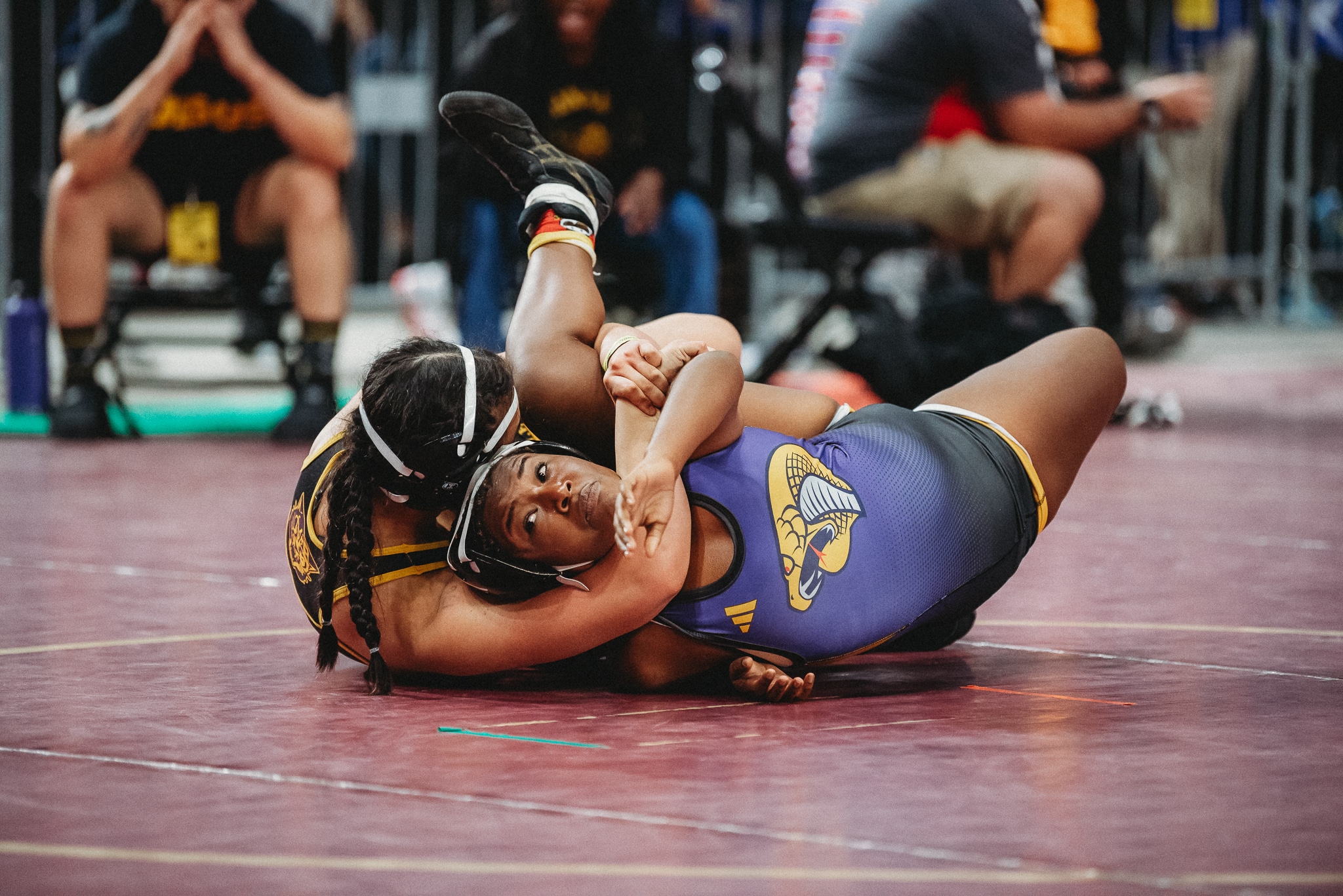 Grace Leota works to pin her opponent in her quarterfinals match against Mia Johnson from Fort Pierce Central. [Credit: Cynthia Leota]