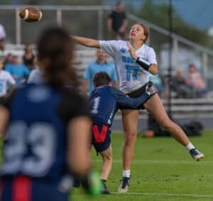 Nature Coast QB, 17, Madelyn DePetrillo gets a pass away for a touchdown just ahead of pressure by Central High’s, 1, Kendra Hammond. [Photo by Joseph DiCristofalo]