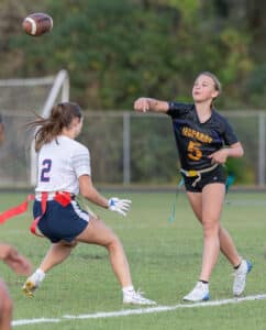 Hernando quarterback, 5, Carlie Grant gets a pass away despite pressure by Springstead High’s Jenna Ludwig, 2, Monday in Brooksville. [Photo by Joe DiCristofalo]