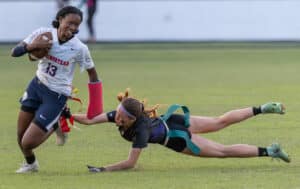 Hernando High, 8, Skyla McCorts makes a diving snare of the flags on Springstead High’s J’Ziyah Mumford, 13, Monday in Brooksville. [Photo by Joe DiCristofalo]