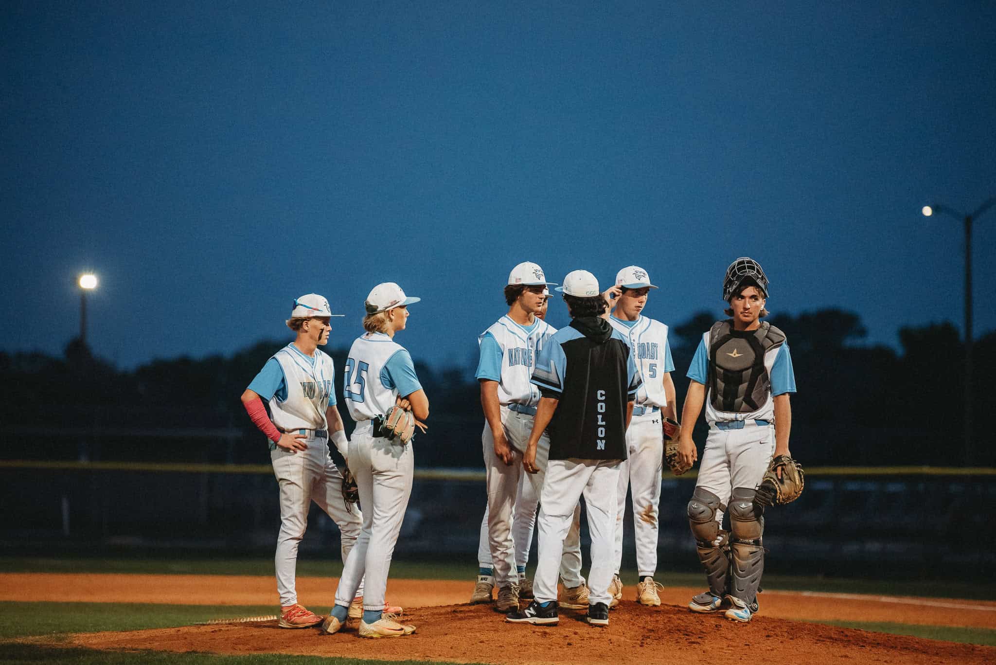 Sharks convene on the mound during Thursday night's game against Cypress Creek. [Photo by Cynthia Leota]