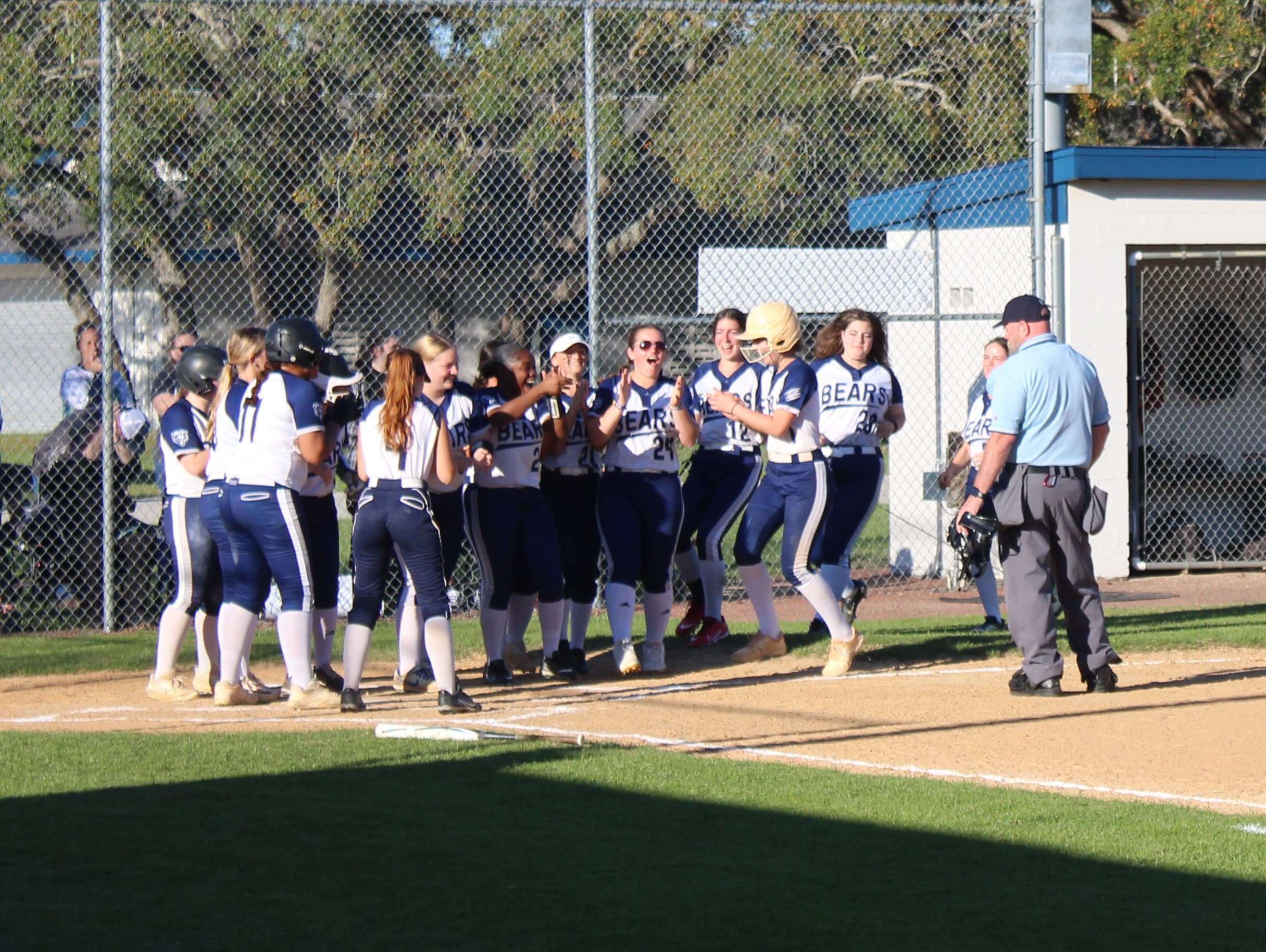 Central players celebrate a homerun by Freshman Ayva Frechette, 1, during Wednesday's softball match. [Photo by Austyn Szempruch]