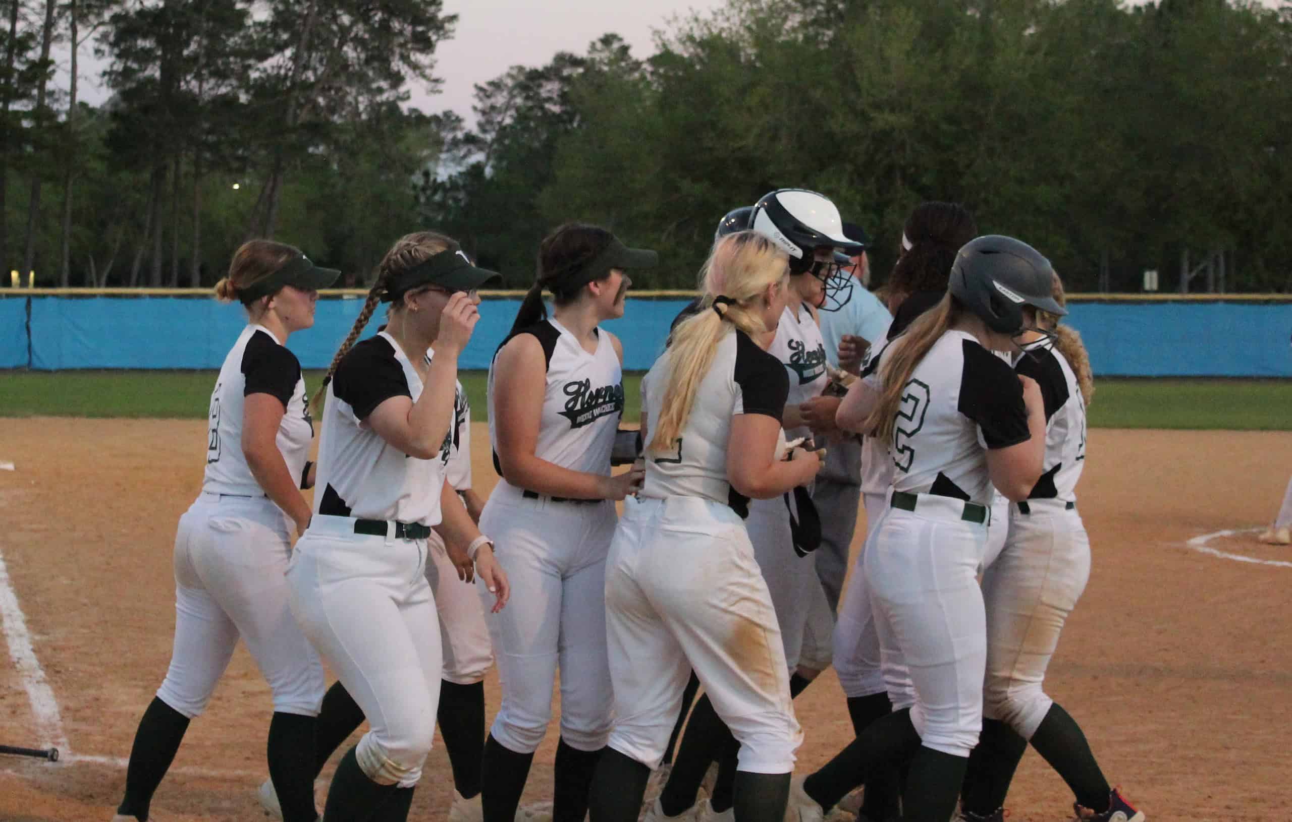 Weeki Wachee players celebrate two-run homerun by Sophomore Hailey Tarner, 11, at home plate on Wednesday. [Photo by Austyn Szempruch]
