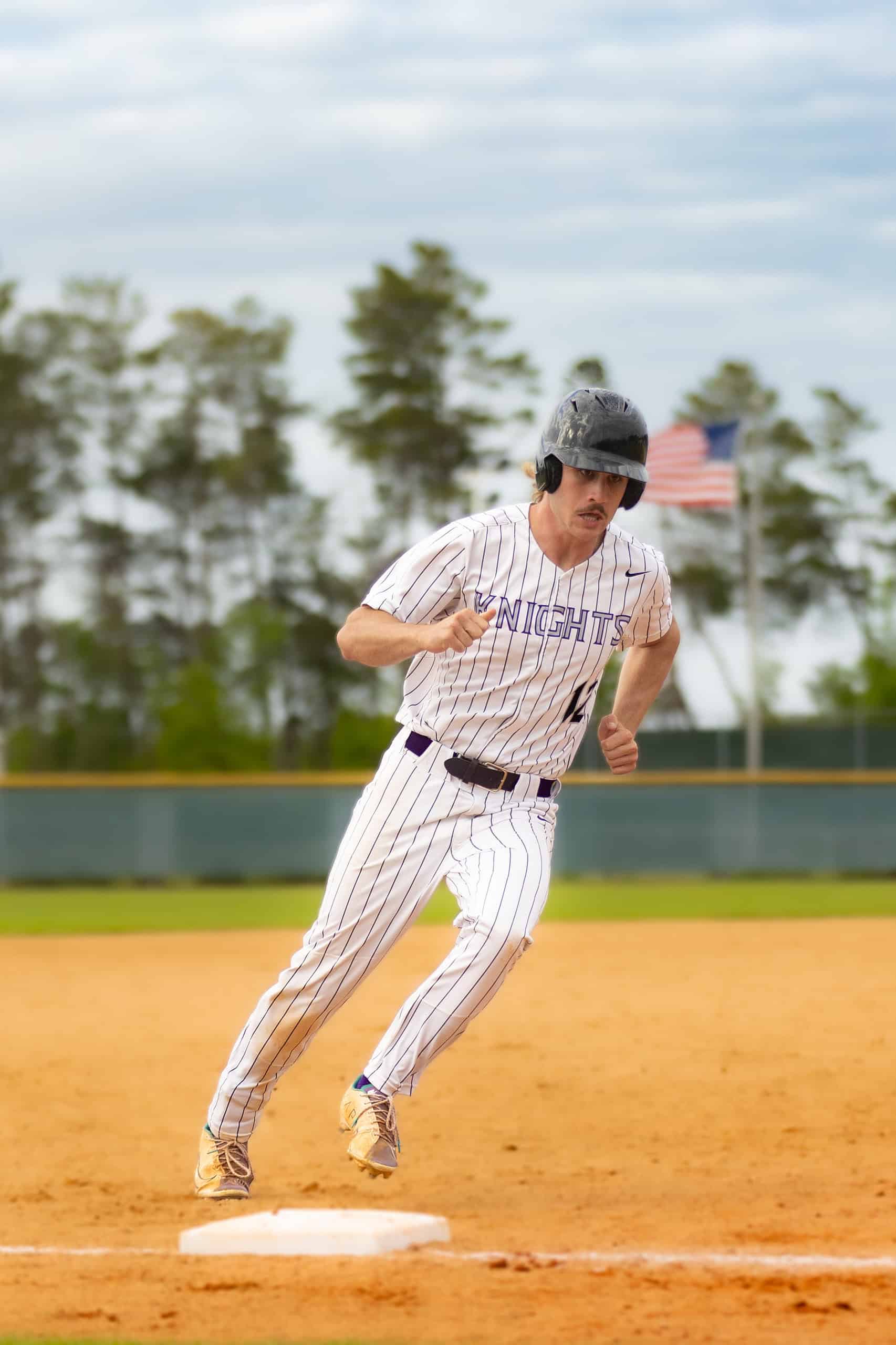 River Ridge, 12, Tyler Johnson rounds third base during the Farm Bureau Invitational Tournament match. [Photo by Kelsie Johnson]