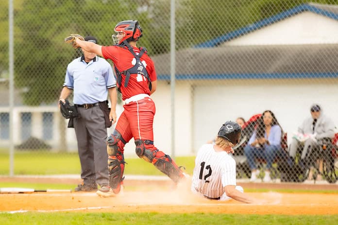 River Ridge, 12, Tyler Jensen slides home during Monday's tournament matchup. [Photo by Kelsie Johnson]