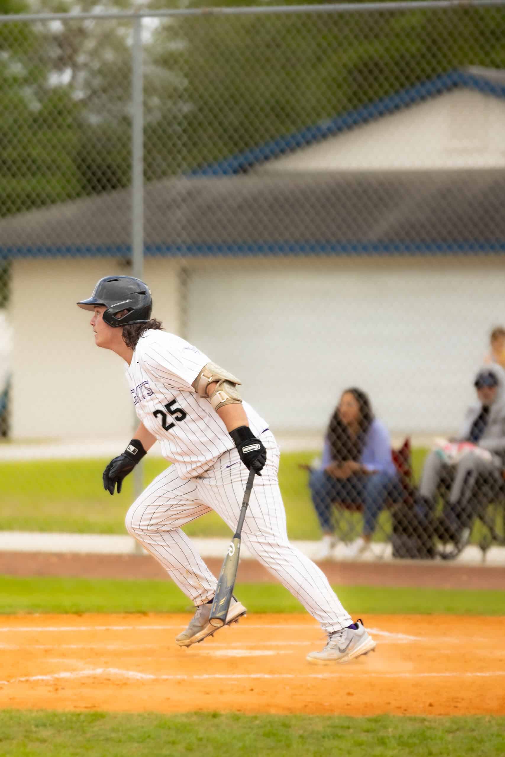 River Ridge, 25, Cameron Kessell readies to run to first after a hit during Monday's tournament matchup. [Photo by Kelsie Johnson]