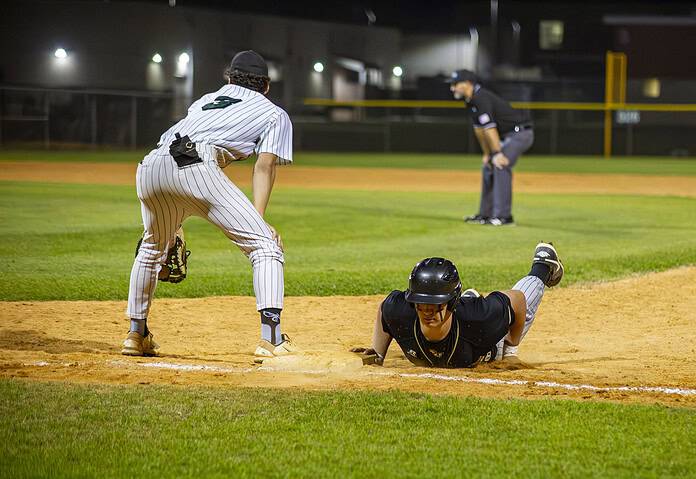 A Citrus player slides back to first base after a failed attempt to steal a base. [Photo by Hanna Maglio]