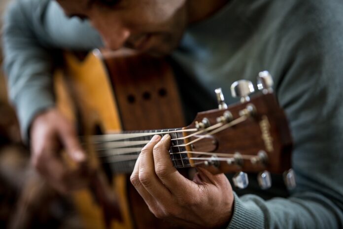 Man playing a guitar.