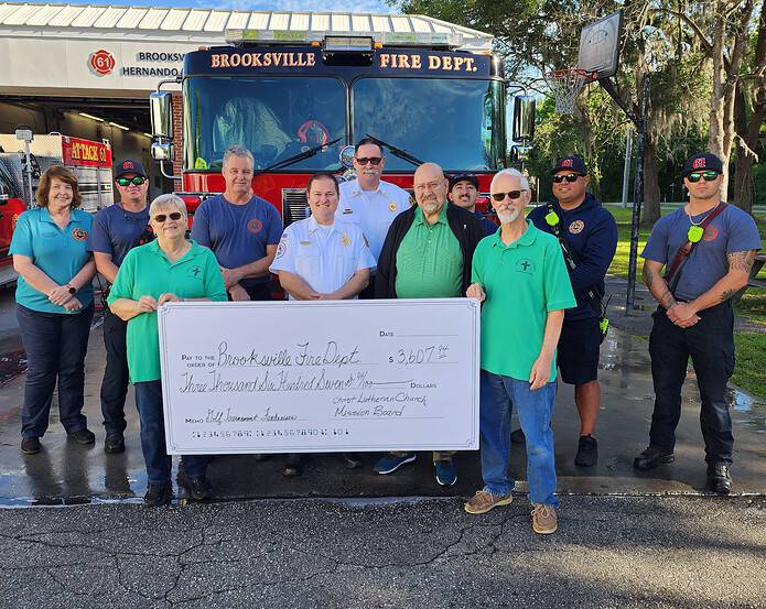 Terry Halladay (left) and Alan Halladay (right) present a check to Fire Chief Brad Sufficool (Middle) and the Brooksville Fire Department. [Credit: Austyn Szempruch]