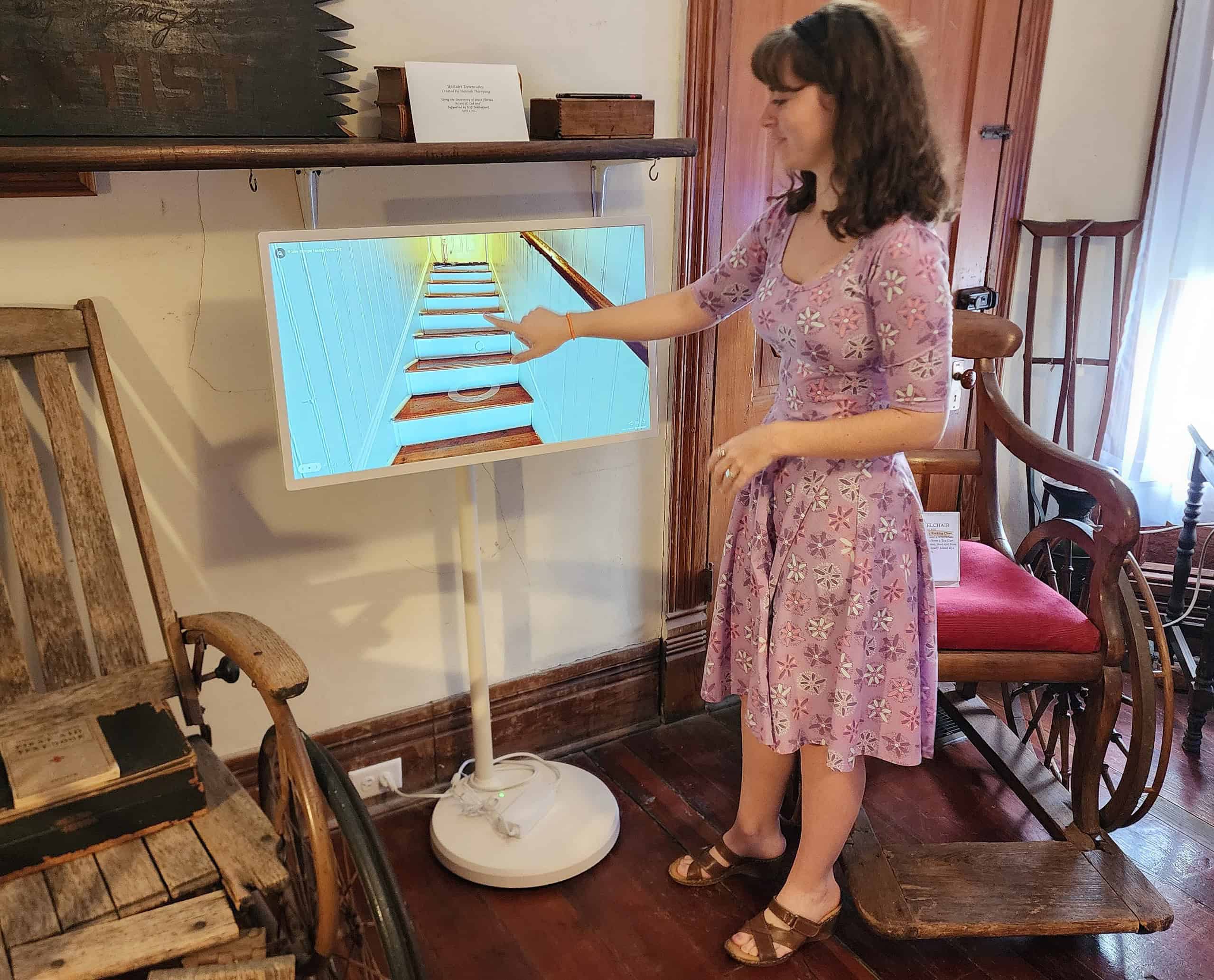 ABOVE: Docent Hannah Thieryung demonstrates how to use the touchscreen kiosk. [Photo by Austyn Szempruch]