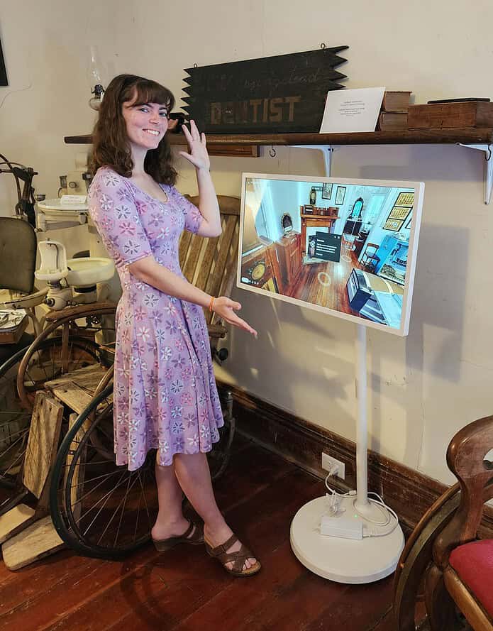 Graduate student Hannah Thieryung stands next to the interactive display that houses her 3D scans and Capstone project. [Photo by Austyn Szempruch]