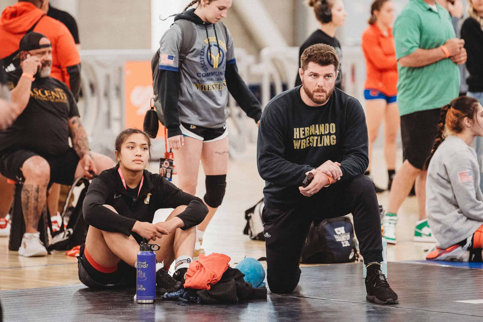 Left to right Grace Leota and Coach David Pritz coaching mat side at Women's Nationals in Spokane, WA. [Photo by Cynthia Leota]