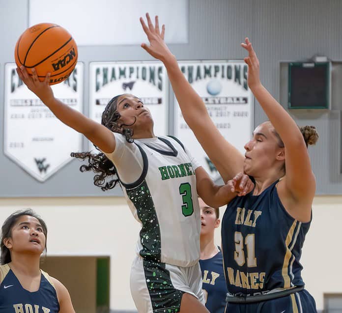 Weeki Wachee, 3, Joelys Rodriguez shoots over Academy of The Holy Names, 31, Hailey Scott in the 4A Region quarterfinal game held at Weeki Wachee High School. [Photo by Joe DiCristofalo]