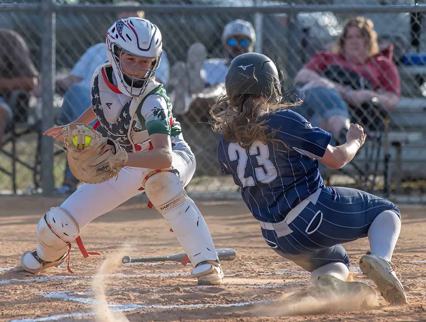 Weeki Wachee High’s catcher, Reagan Miller tries to put a tag on Central High’s Kaylee Reese ,23, as she scores in the 10 run first inning for the Bears in the 4A District 5 playoff game . Photo by [Joseph Dicristofalo]