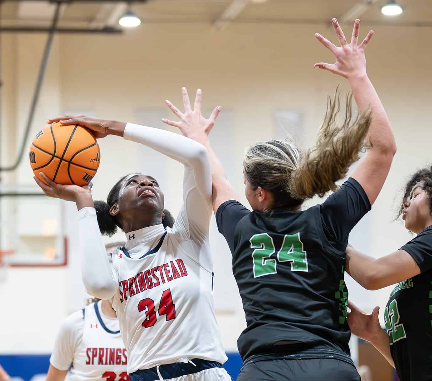 Weeki Wachee High’s Marlee Schumacher attempts to block a shot by Springstead High’s, 34, Melanie Francis. [Photo by Joe DiCristofalo]