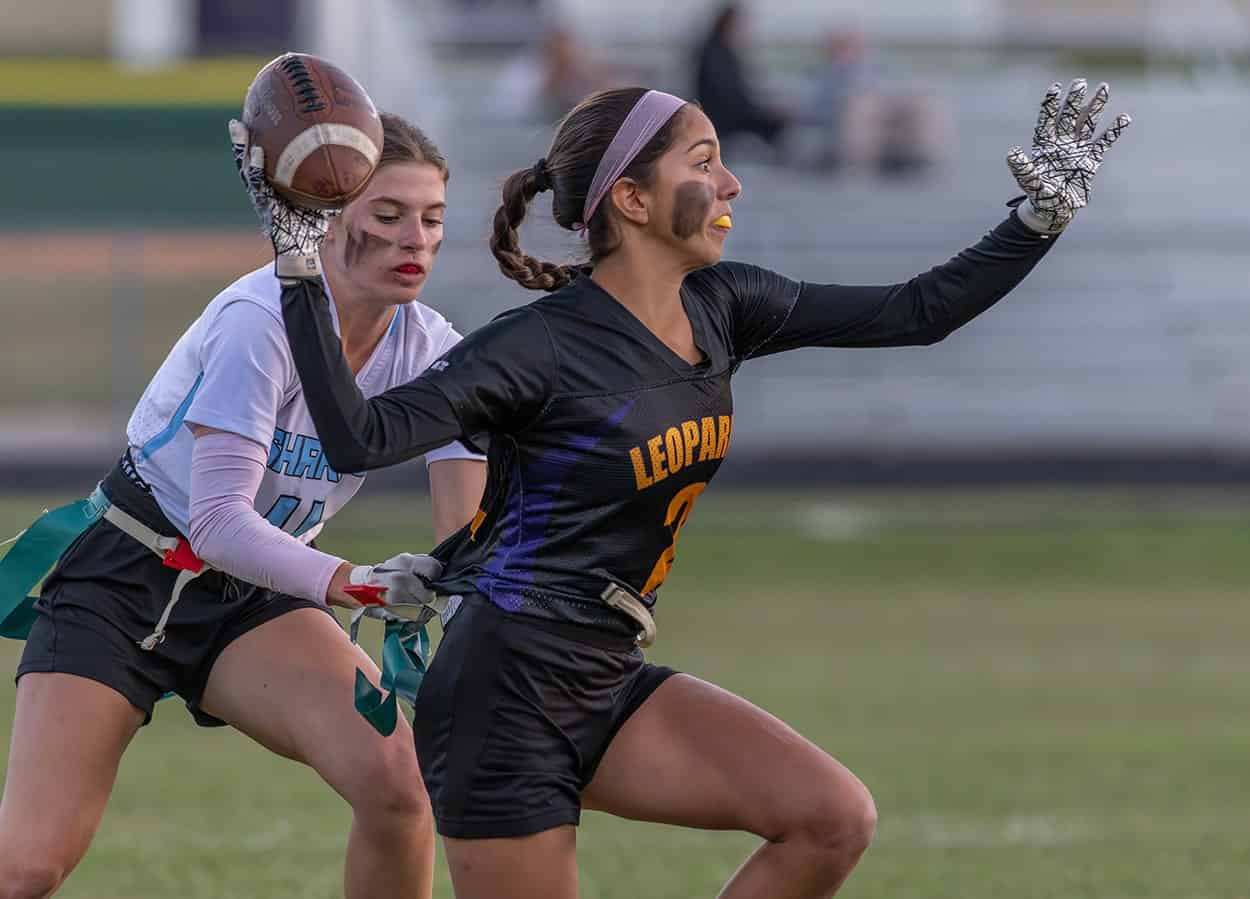 Hernando quarterback, 2, Jackie Cuevas has her flag pulled by Nature Coast Tech, 4, Athena Brown before she was able to get off a pass Thursday at Hernando High. Photo by [JOE DiCRISTOFALO]