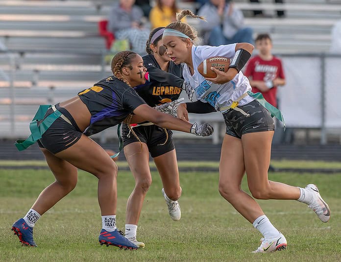 Nature Coast Tech, 28, Olivia DiFrank tries to evade Hernando High’s, 7, Shane Radford and, 2, Jackie Cuevas Thursday at Hernando High. Photo by [JOE DiCRISTOFALO]