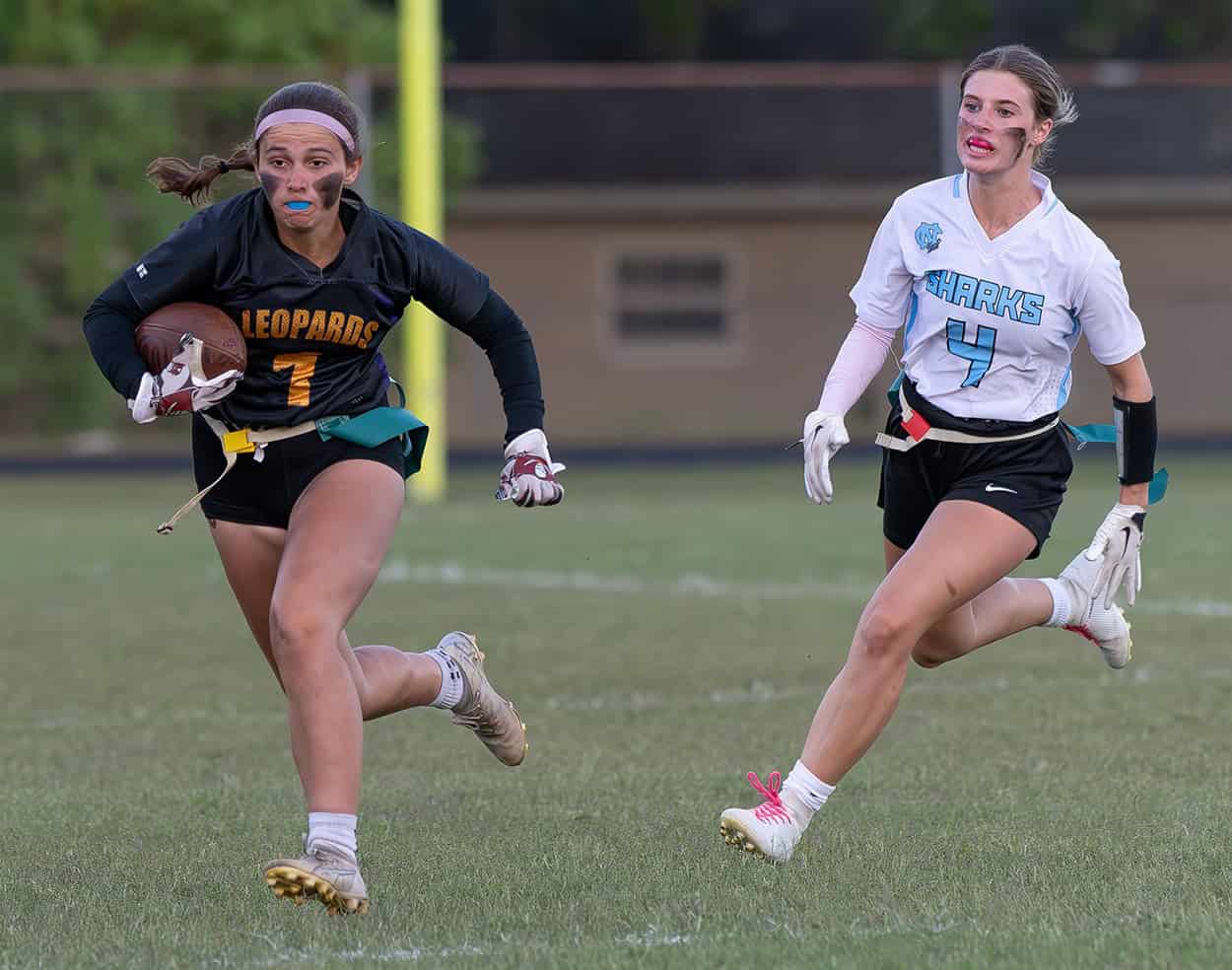 Hernando High, 1, Annabelle Chamberlain runs for yardage pursued by Nature Coast Tech, 4, Athena Brown Thursday at Hernando High. Photo by [JOE DiCRISTOFALO]