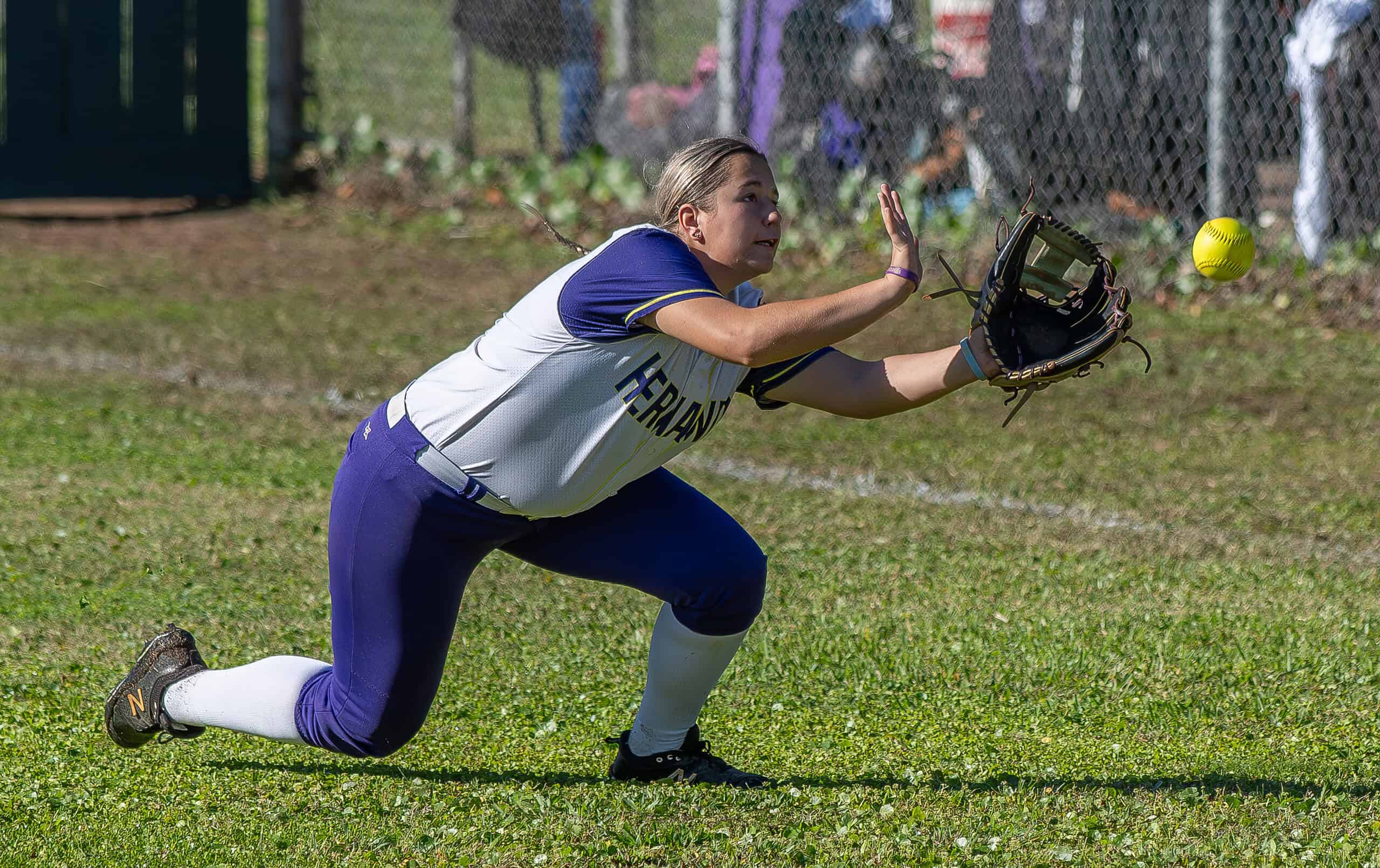 Hernando High right fielder Shyann Lynch had this sinking line drive narrowly elude her grasp early in the opening game of the Leopard Slam tournament at Tom Varn Park. [Photo by Joe DiCristofalo]