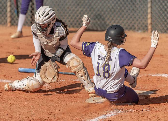 Hernando High’s Lillian Jernigan slides into home in the opening game of the Leopard Slam tournament at Tom Varn Park. [Photo by Joe DiCristofalo]