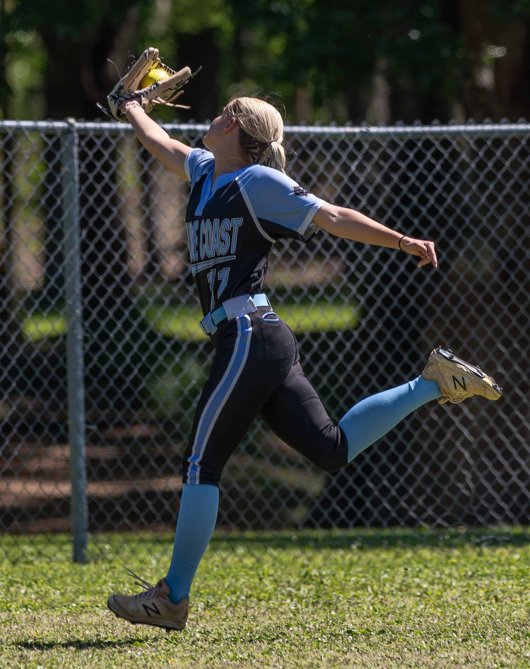 Nature Coast Tech centerfielder Kenzie Eland, 11, runs under a deep line drive in the Shark’s opening round extra inning loss to Cornerstone Charter Academy in the Leopard Slam tournament at Tom Varn Park. [Photo by Joe DiCristofalo]