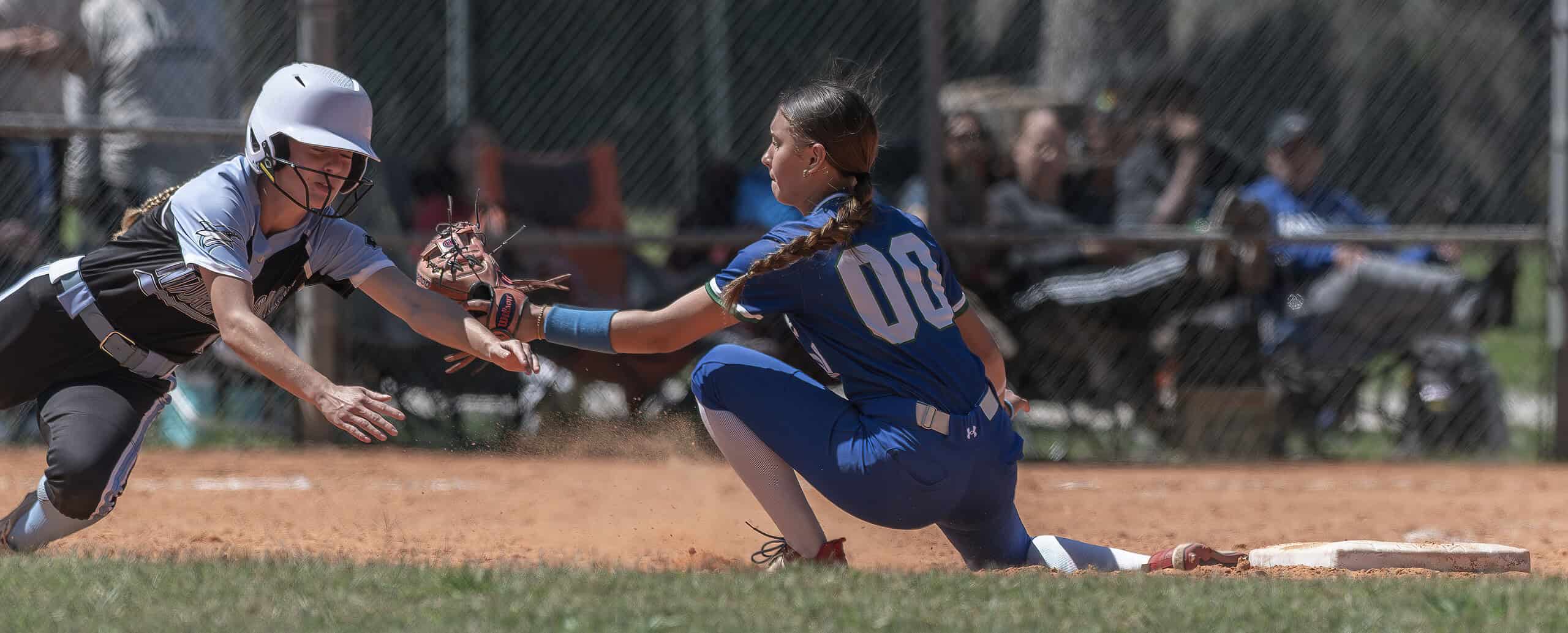 Nature Coast Tech’s Caitlin Corrigan gets tagged by Cornerstone Charter Academy shortstop ,00, Yami Cordova in the Leopard Slam tournament at Tom Varn Park. [Photo by Joe DiCristofalo]