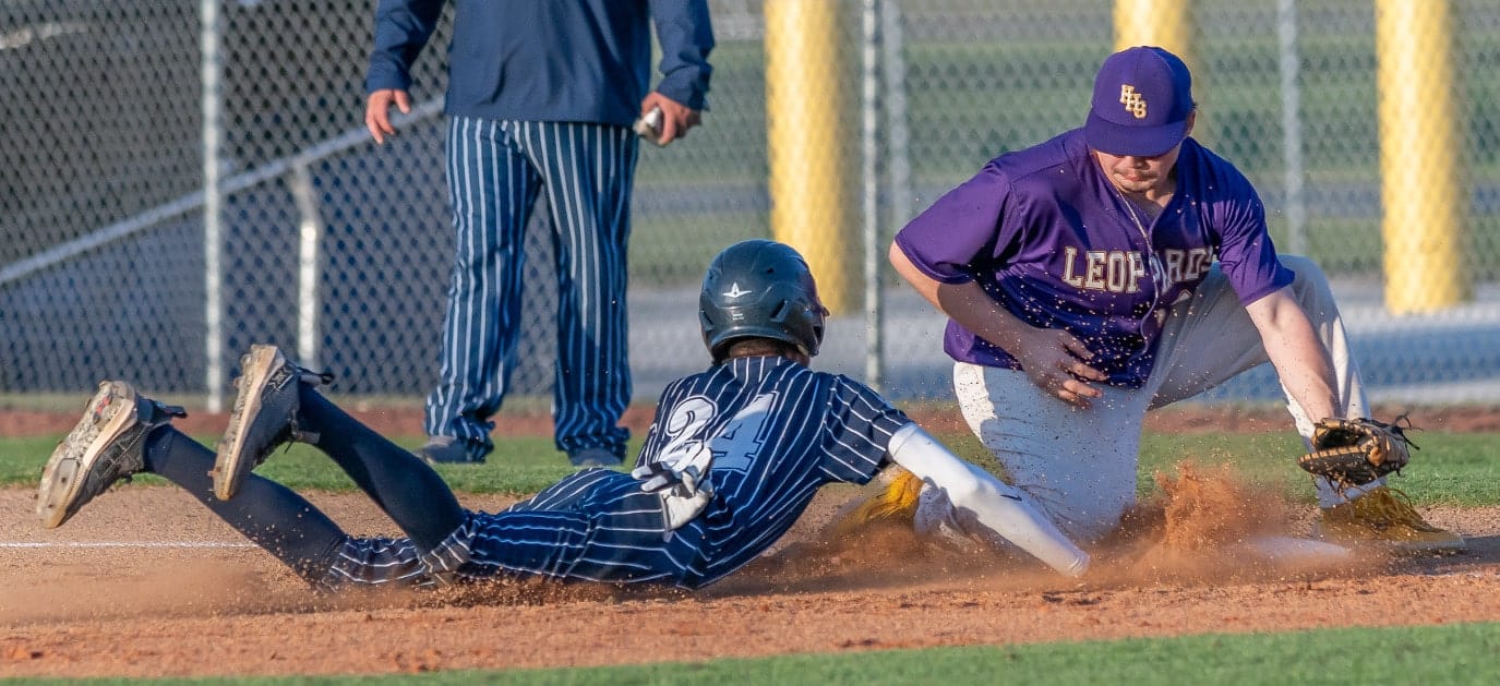 Central High, 24, Jayden Warren dive back to first base before Hernando High first baseman Eric O’Dell could apply a tag Friday at Central High. Photo by [Joseph Dicristofalo]