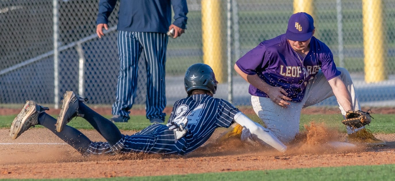 Central High, 24, Jayden Warren dive back to first base before Hernando High first baseman Eric O’Dell could apply a tag Friday at Central High. Photo by [Joseph Dicristofalo]