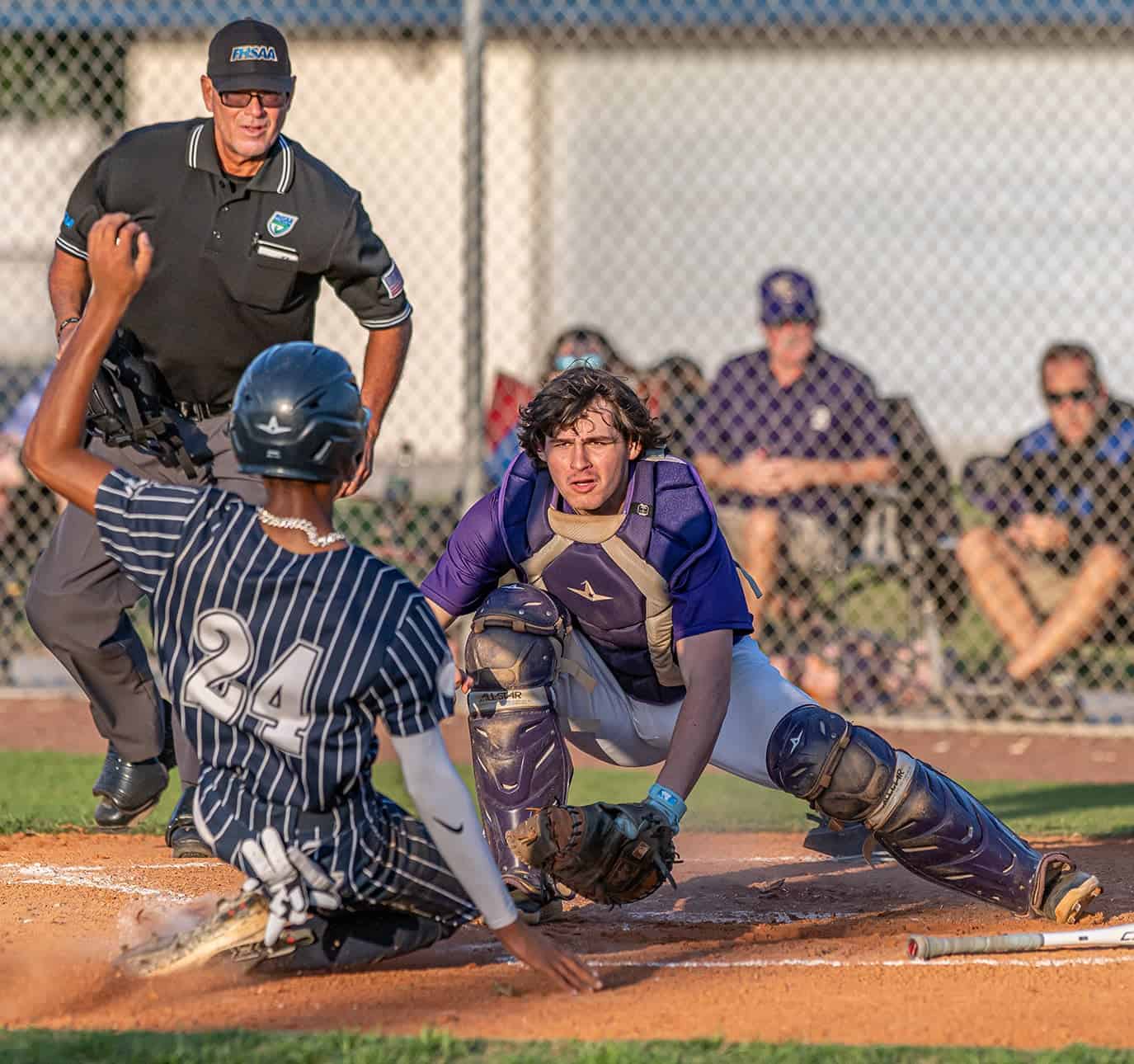 Hernando High catcher Kaine Ellis waits to put a tag on sliding Central High base runner, 24, Jayden Warren Friday in Brooksville. Photo by [Joseph Dicristofalo]