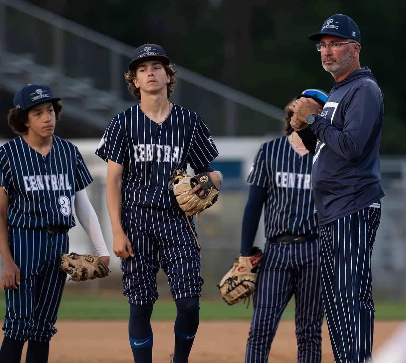 Central High Head Coach Al Sorrentino waits on the mound during a pitching change in the game against visiting Hernando High Friday. Also pictured Korbin Baskind, center, and 36, Jacob Lugo. Photo by [Joseph Dicristofalo]
