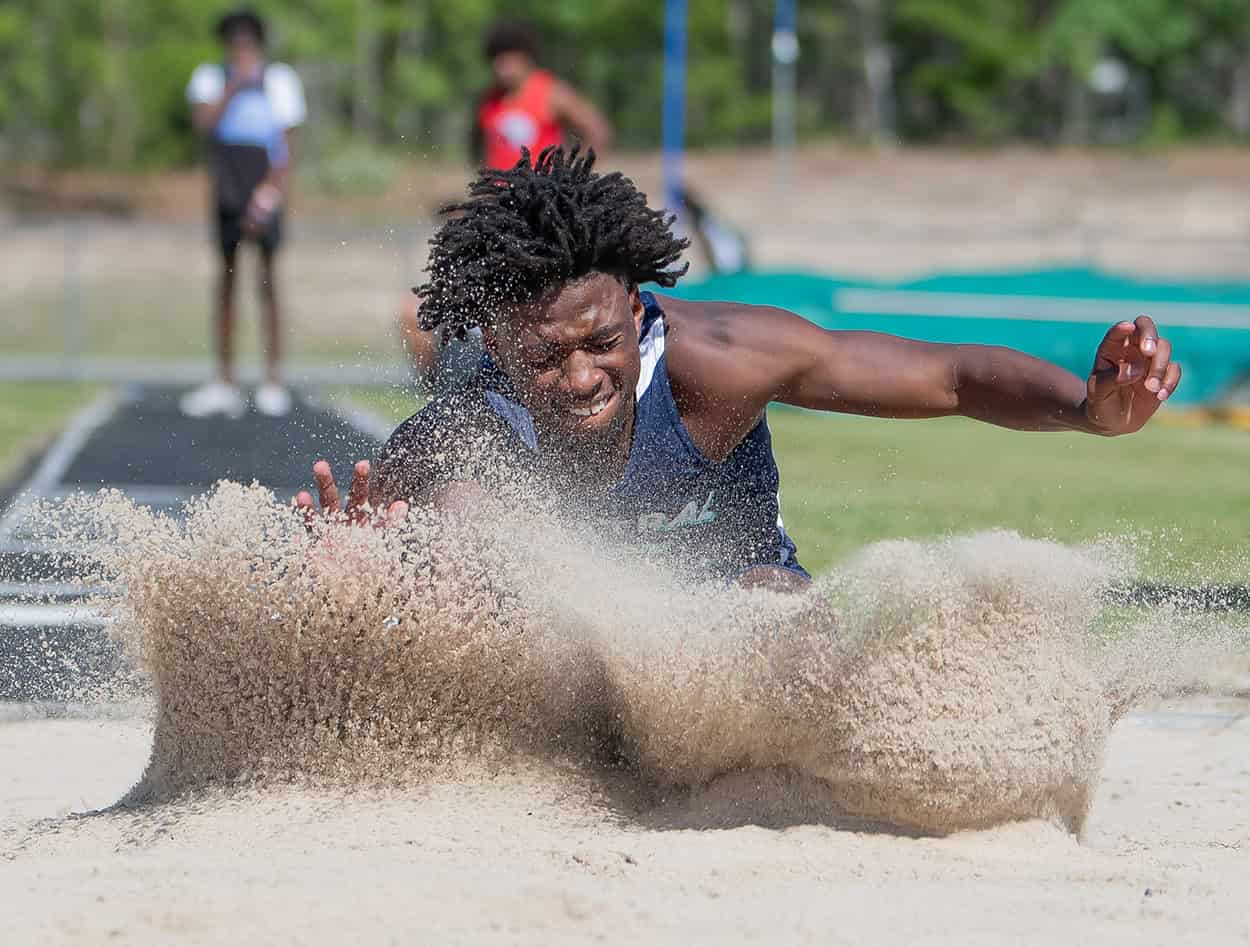 Central High’s Ja'Corry Graham sticks his landing in the long jump event at the GC8 Track and Field Championships at Weeki Wachee High School. Photo by [Joe DiCristofalo]