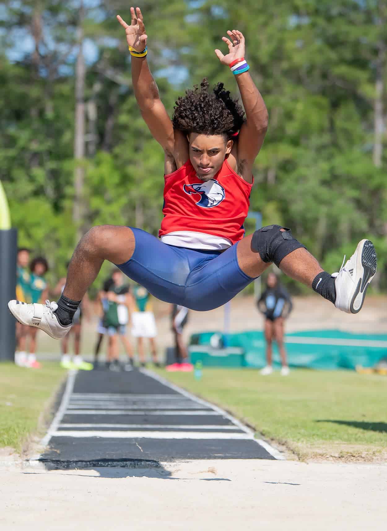 Springstead High’s Chadiell Echavarria takes flight in the long jump event at the GC8 Track and Field Championships at Weeki Wachee High School. Photo by [Joe DiCristofalo]