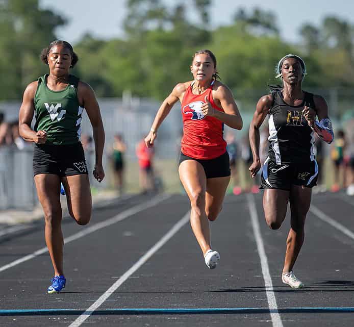 The women’s 100 meter dash, Weeki Wachee Jasmine Randazzo bested 2nd place Hernando High Lentajhae Smith and Springstead's Ava Kanaar third at the GC8 Track and Field Championships at Weeki Wachee High School. Photo by [Joe DiCristofalo]