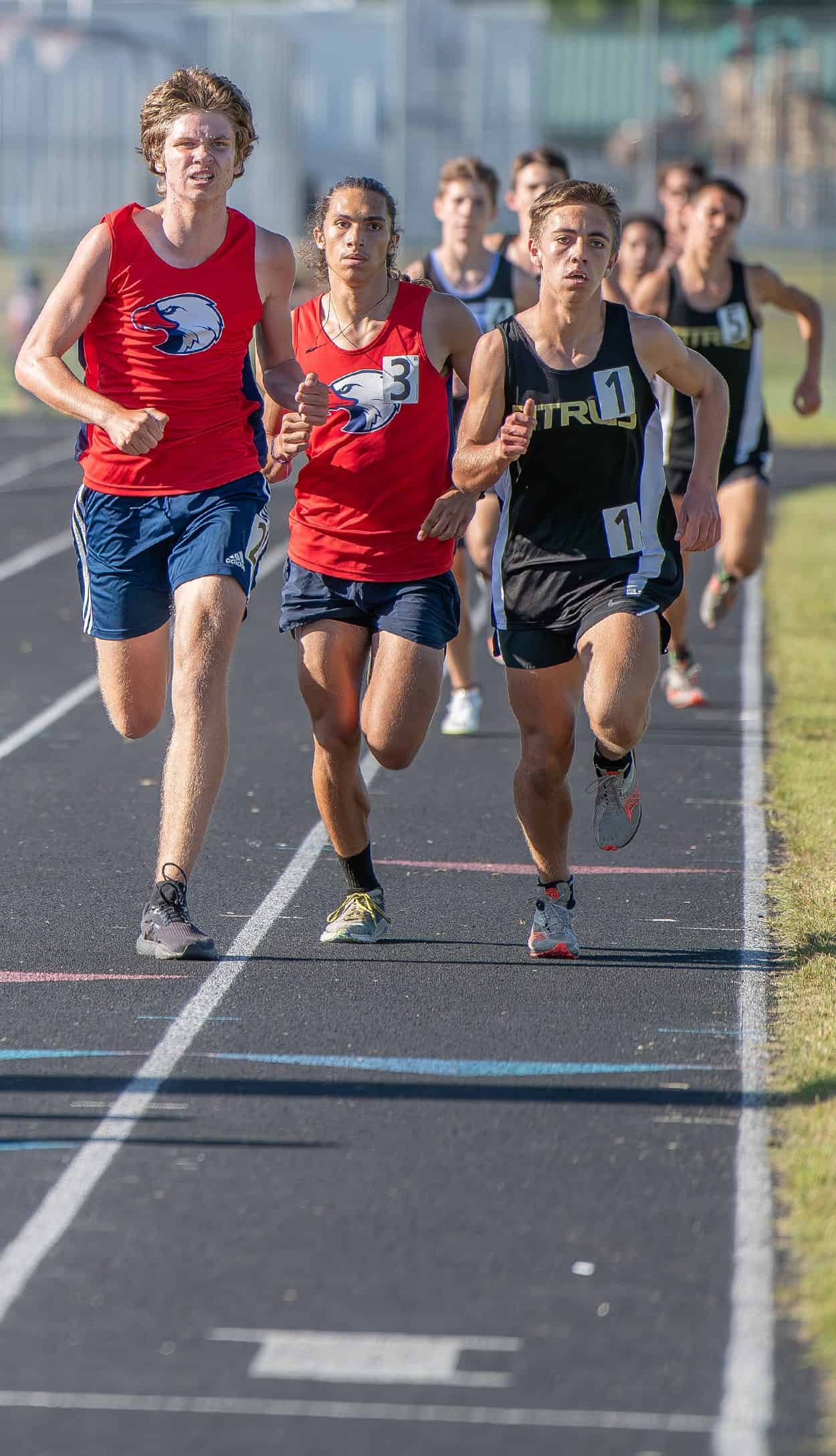 Springstead’s Isaac Rosario, 3, eventually overcame fellow Springstead competitor Zachary McCollum and Citrus High’s Miles Tobin to win the Men’s 1600 at the GC8 Track and Field Championships at Weeki Wachee High School. Photo by [Joe DiCristofalo]
