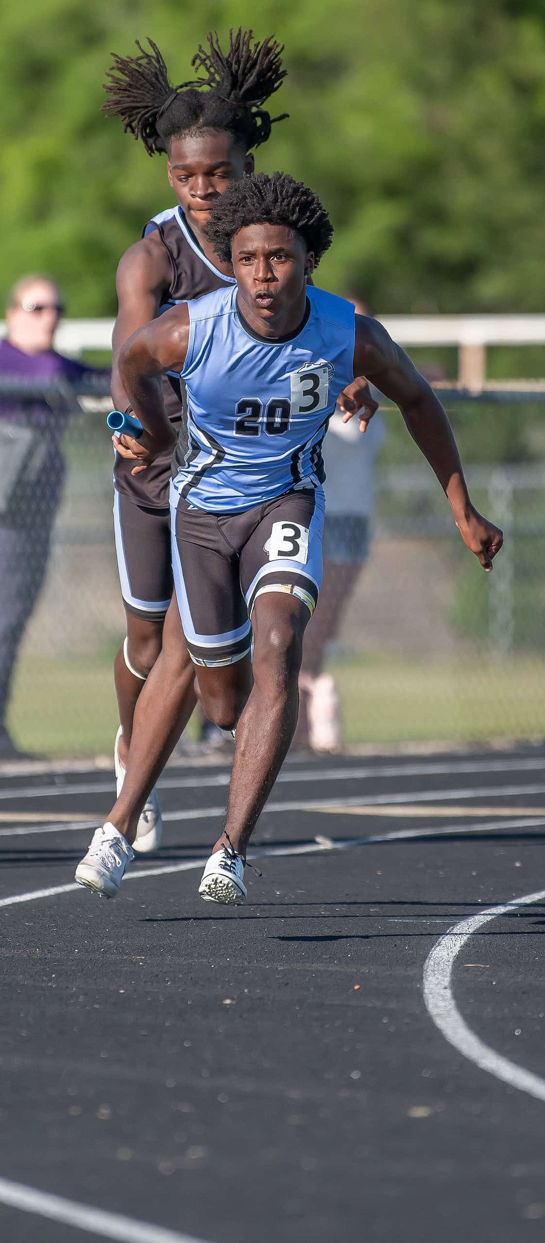 Nature Coast Tech’s Zayden McKenzie takes the baton from Trent Montgomery to anchor the 4x100 to first place at the GC8 Track and Field Championships at Weeki Wachee High School. Photo by [Joe DiCristofalo]