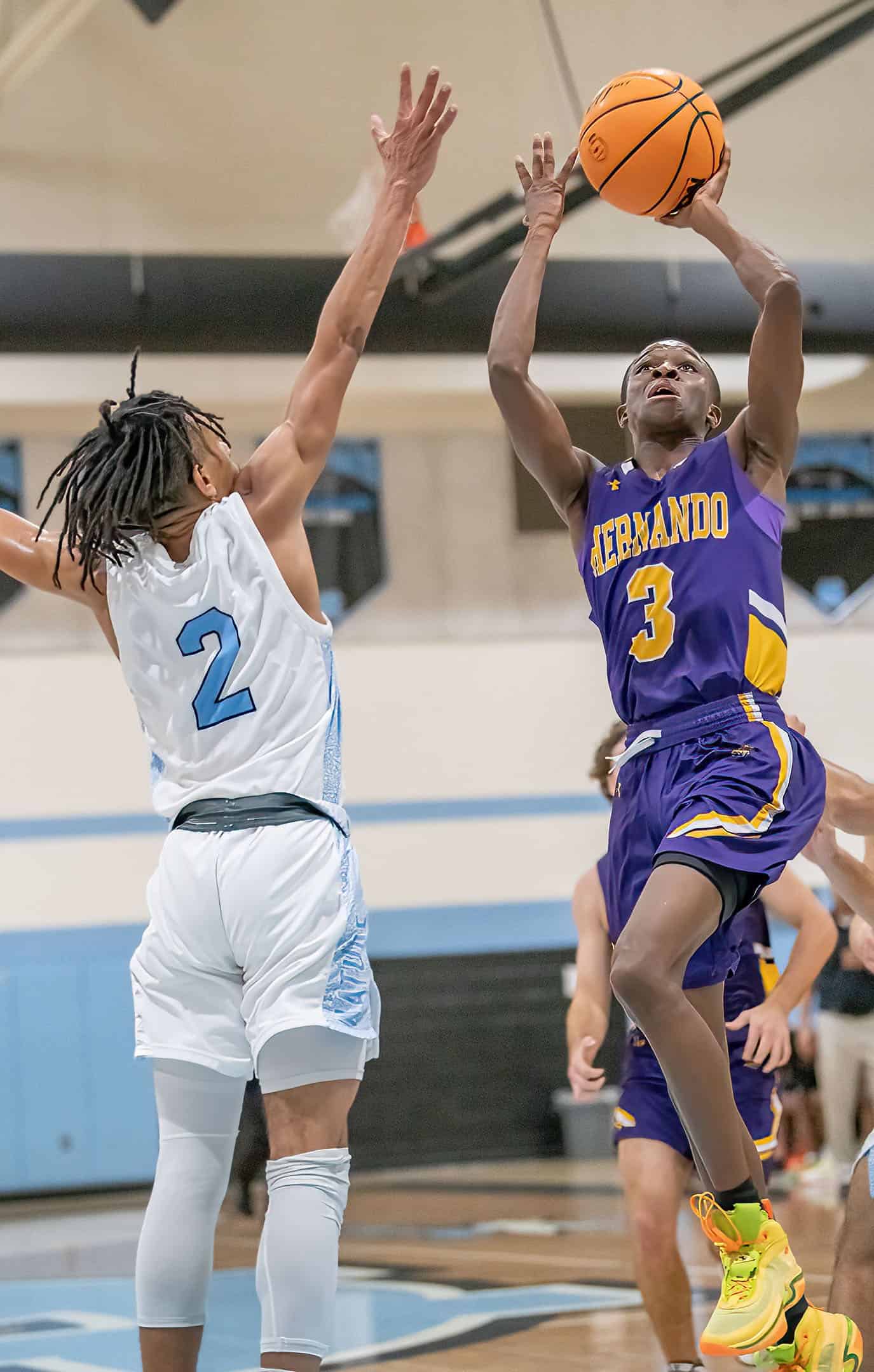 Hernando High, 3, Josiah Wright shoots over the defense by NCT, 2, Sheldon Cotton. [Photo by Joe DiCristofalo]