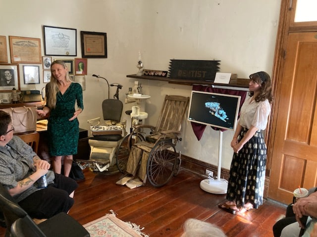 Dr. Jennifer Knight (left) and Hannah Thieryung (right) educate attendees on the details of the interactive display. [Photo by Mary Sheldon]