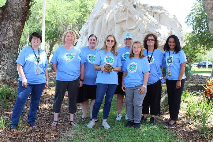 PHSC staffers (left-right) Amy Eichelberger, Sandre Lyons, Nava Cohen, Heather Reddig, Janet Dean, Kelly Hockenbrough, Jodi Van Slee, and Adriana Bridger celebrate Earth Day.