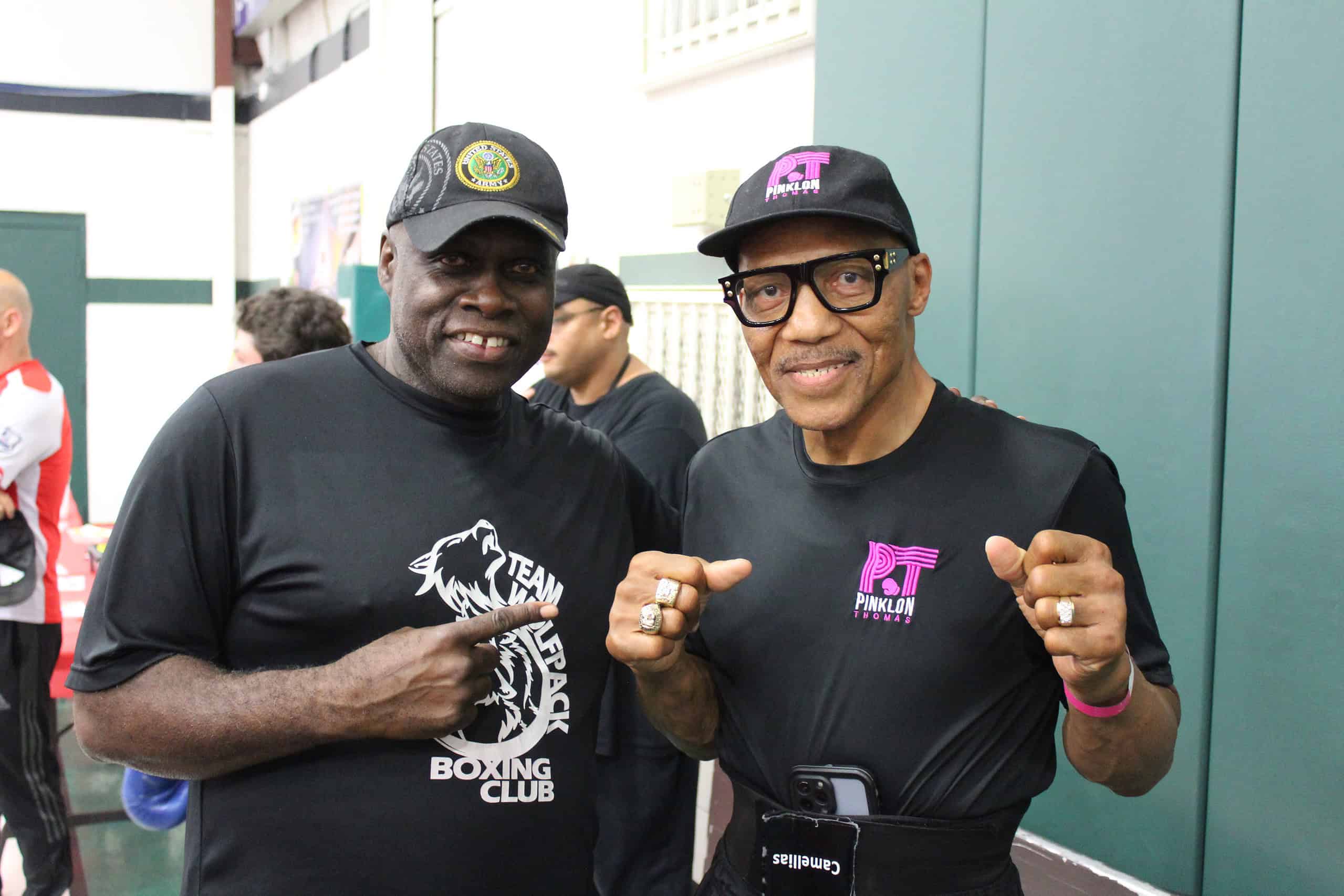 Coach Wilson (left) poses with legendary boxer Pinklon Thomas (right) at the Florida Junior Olympics.