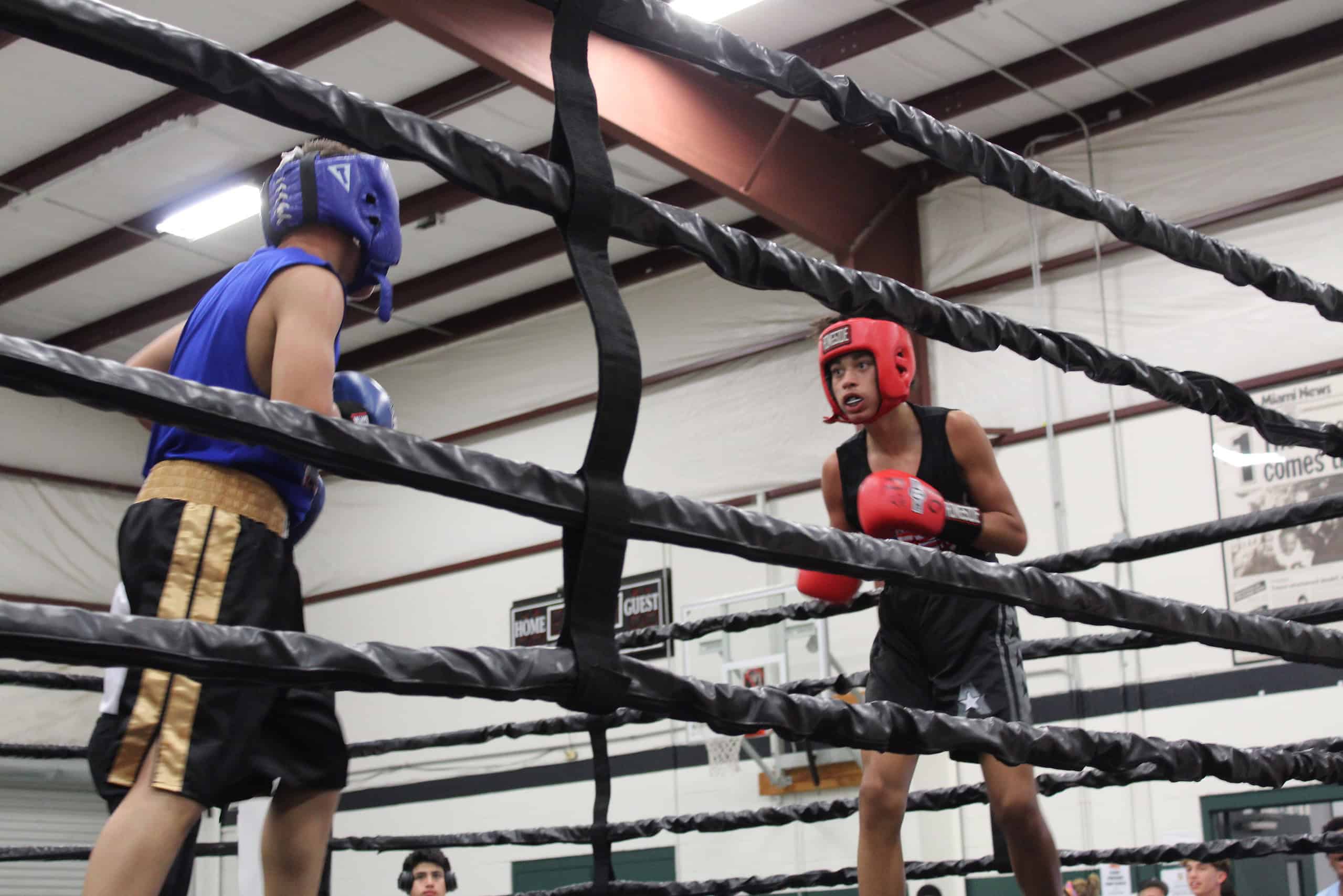 Joshua Aqueron (right) faces off against Cruz Palacios (left) in the ring.
