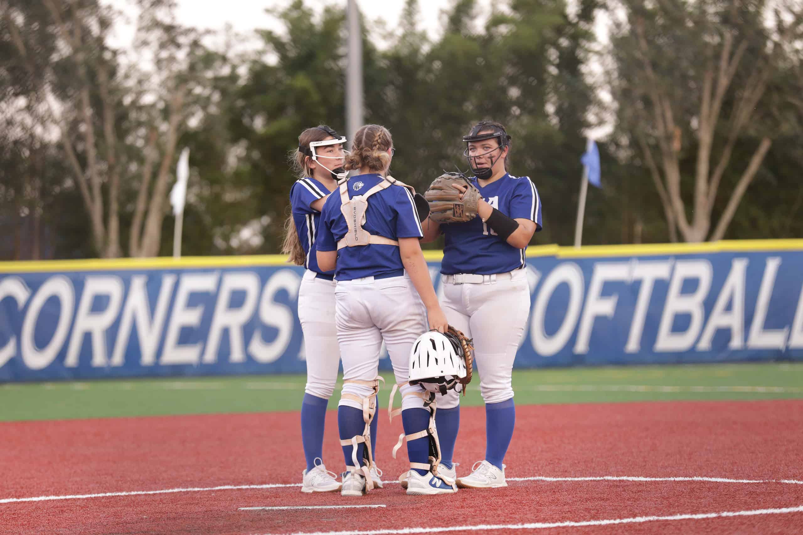 Lions' Shortstop Rae Easton, Pitcher Kaylana Lyons, and Catcher Piper Gill taking a timeout during Wednesday's postseason softball matchup. [Photo Provided by Sean Gill]