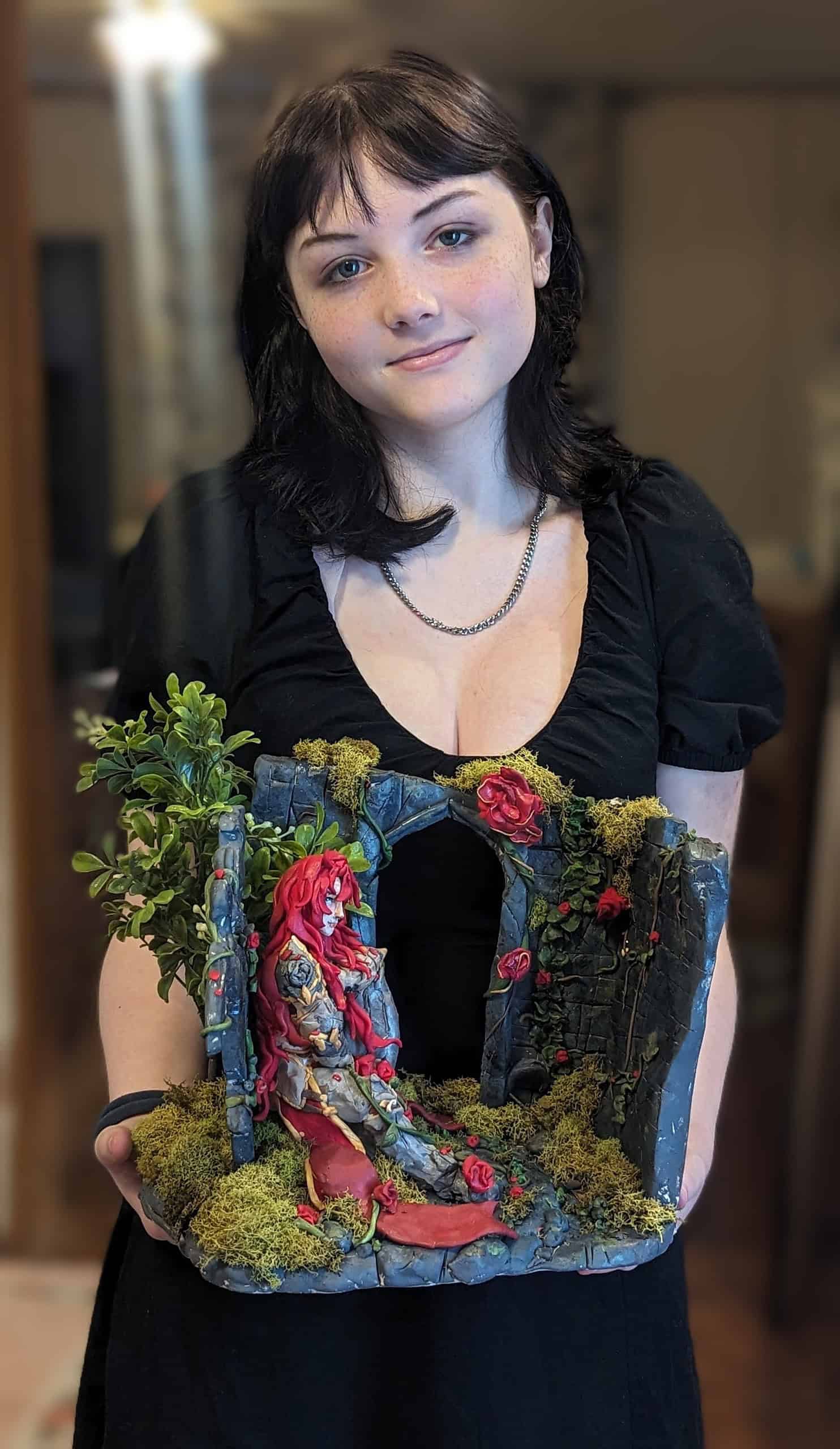 Kaitlyn Stires with her sculpture “Knight of Beauty.” [Photo courtesy of Michelle Pate-Stires]