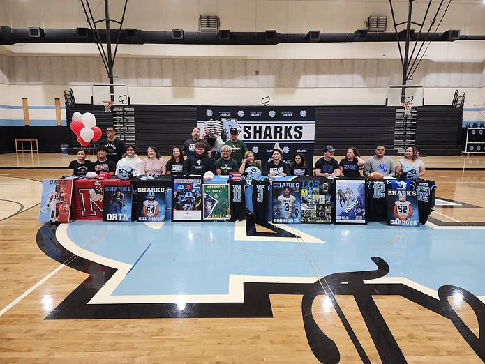 The college signees pose for a group photo with family during the ceremony. [Photo by Austyn Szempruch]