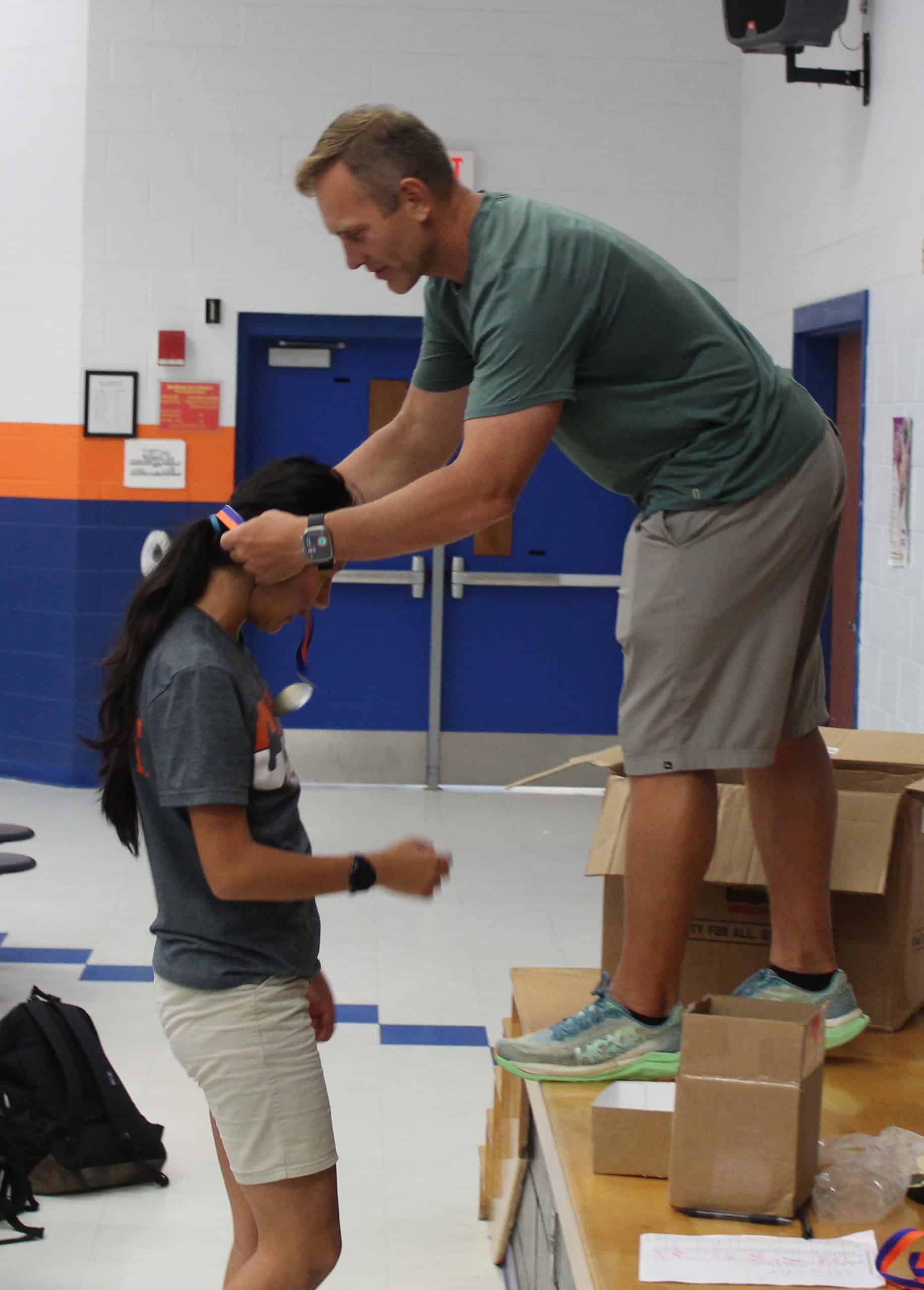 Head Coach David Barrett gives Lainee Mercer an award on Thursday. [Photo by Austyn Szempruch]