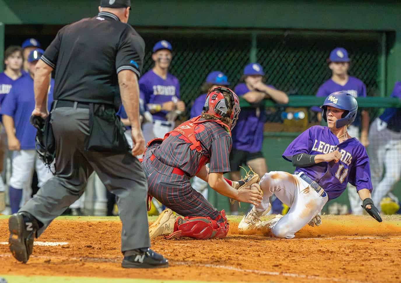 Hernando High’s Braden Harmon was able to score when the Hudson Cobra catcher, Baylor Lloyd, lost possession of the ball during this play at the plate Wednesday during the 4A District 6 semifinal in Brooksville. [Photo by Joseph DiCristofalo]