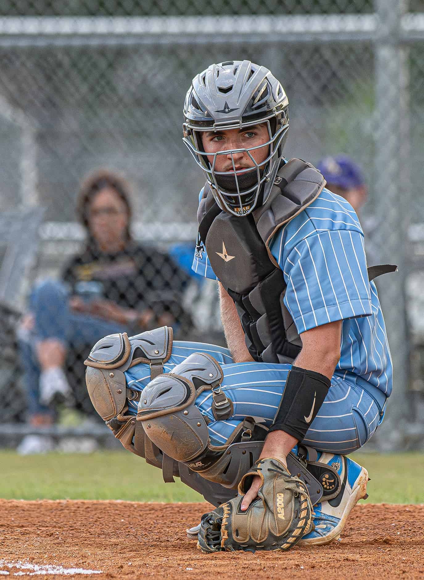Nature Coast Tech catcher, Brady McMurdo looks to the dugout to get the pitch choice during the game versus Hernando High in the 4A District 6 title game. Photo by [Joseph Dicristofalo]