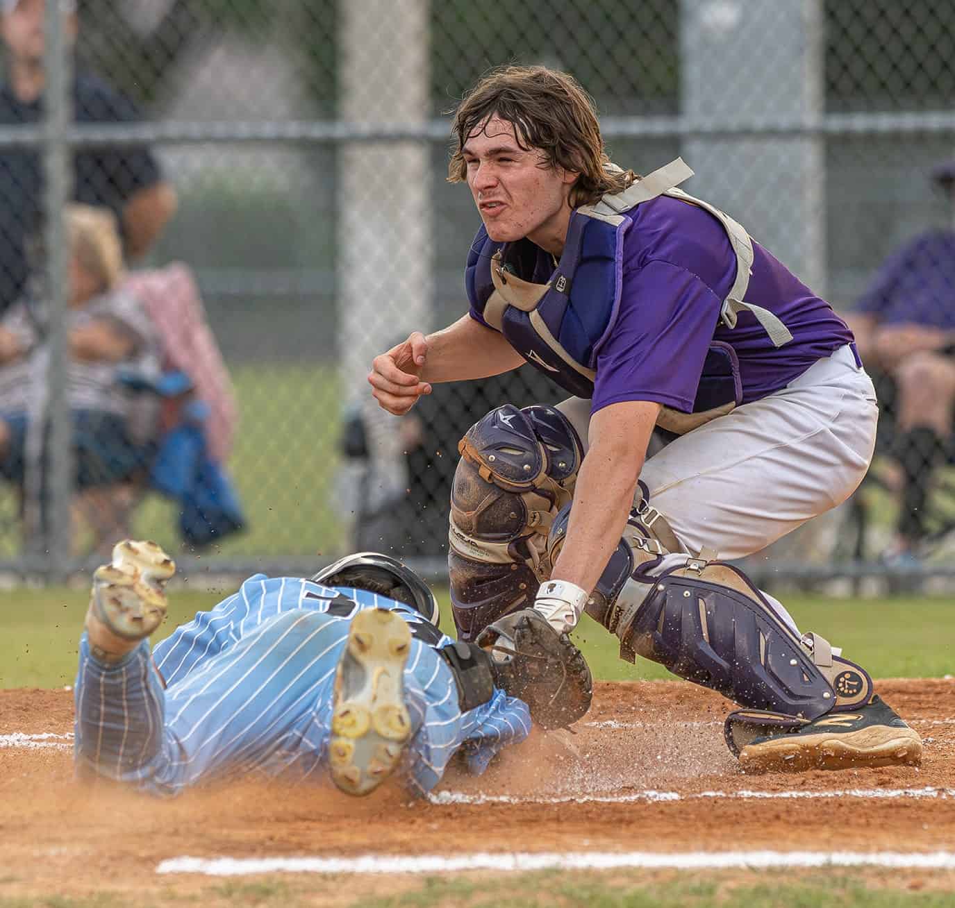 Hernando High School’s catcher, Kaine Ellis, puts the tag on Nature Coast Tech's sliding Cashis Williams in the first inning during the 4A District 6 title game played at NCT. Photo by [Joseph Dicristofalo]