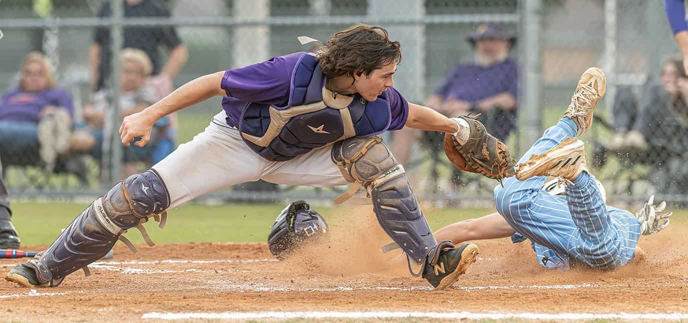Nature Coast Tech’s Bryce Hewell slides past the tag attempt by Hernando High’s Kaine Ellis in the 4A District 6 title game. Photo by [Joseph Dicristofalo]